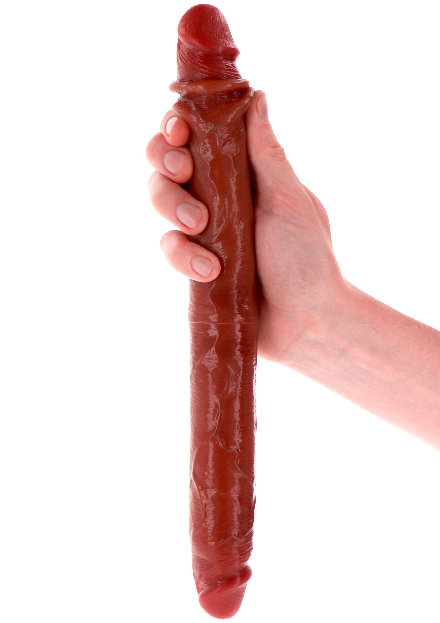 Gode marron texturé, tenu dans une main. Plaisir intense garanti ! ; Textured bruine dildo in de hand. Gegarandeerd intens plezier!; Textured brown dildo held in hand. Guaranteed intense pleasure!