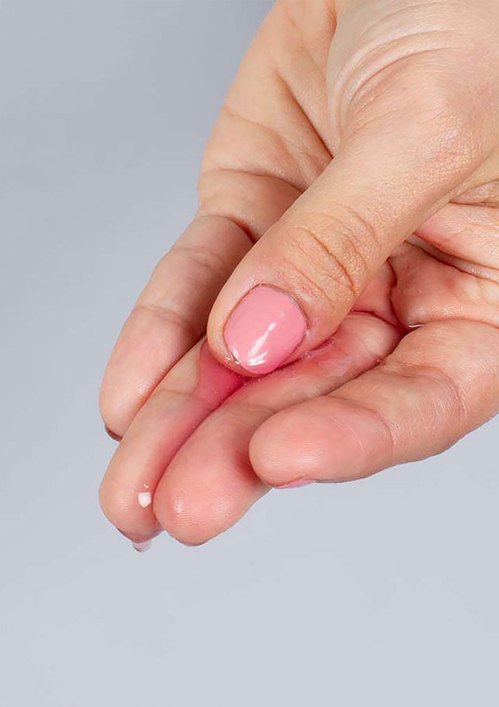 Main tenant un sérum de beauté. Texture douce et hydratante pour une peau éclatante. Achetez maintenant!; Hand houdt schoonheidsserum vast. Zachte en hydraterende textuur voor een stralende huid. Koop nu!; Hand holding beauty serum. Soft & hydrating texture for glowing skin. Shop now for radiant results!