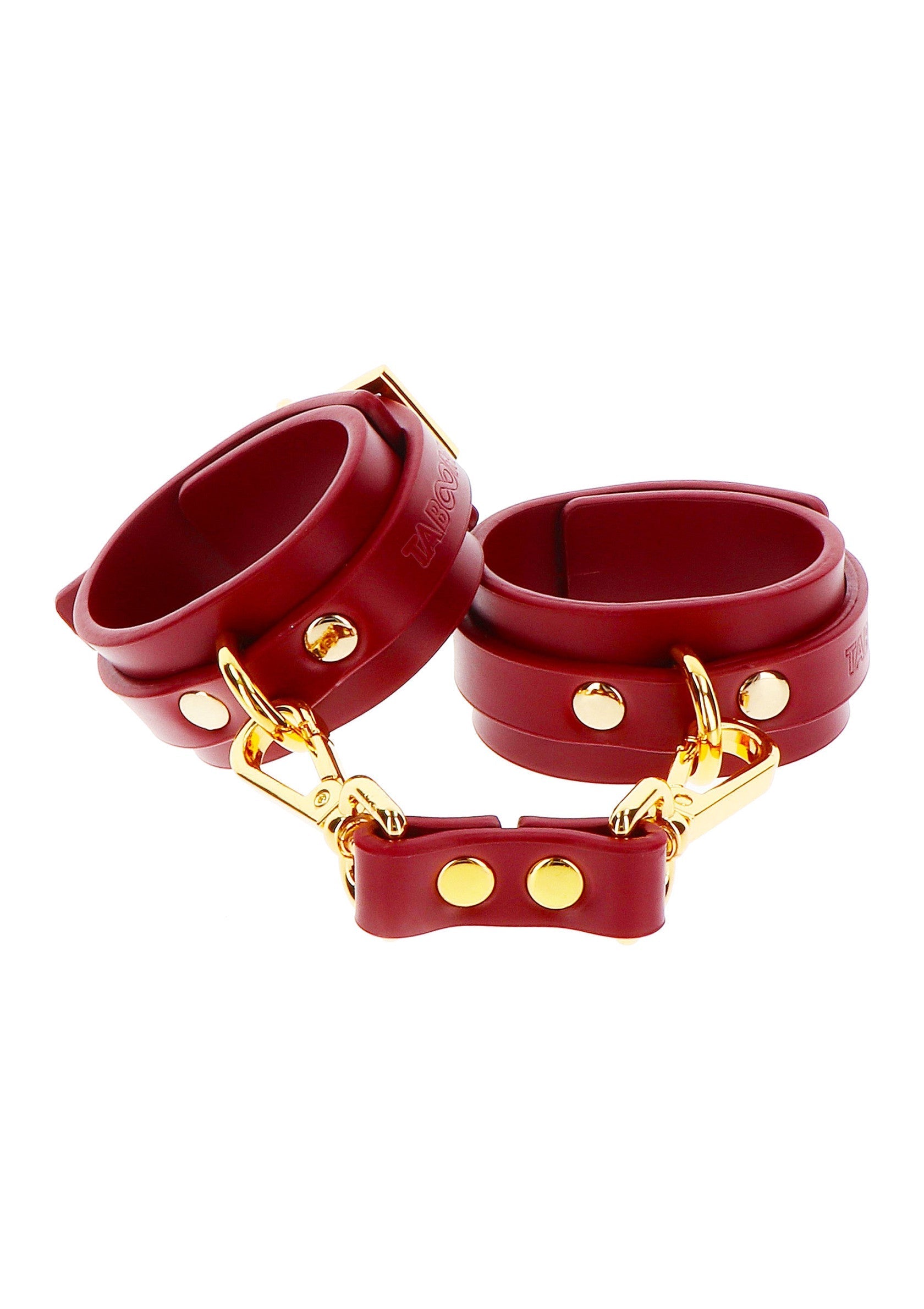 Menottes rouges en cuir avec détails dorés pour des jeux coquins.; Rode leren handboeien met gouden details voor stout spel.; Red leather handcuffs with gold details for kinky play.