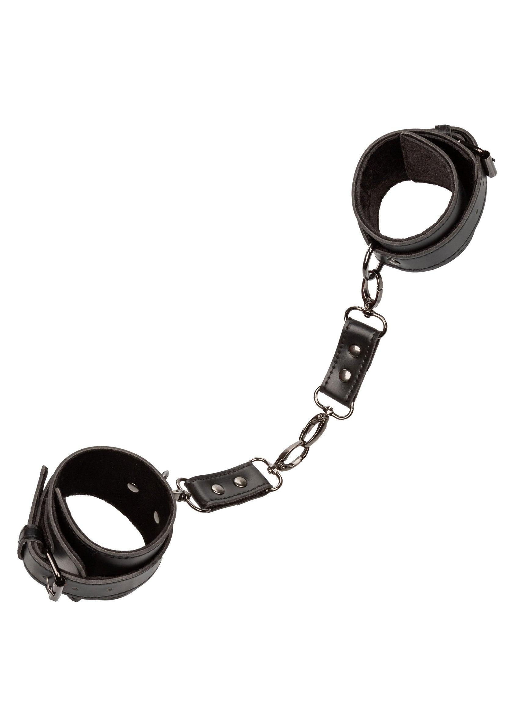 Menottes en cuir noir reliées par une chaîne, pour jeux coquins et domination.; Zwarte leren handboeien met ketting, voor stout spel en dominantie.; Black leather handcuffs linked by a chain, for kinky play and domination.