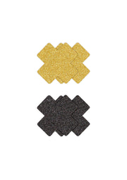 Cache-tétons pailletés croisés. Accessoires de mode festifs et glamour en or et noir.; Glitter tepelplakkers in kruisvorm. Feestelijke en glamoureuze mode accessoires in goud en zwart.; Glitter nipple pasties in cross shape. Festive and glamorous fashion accessories in gold and black.