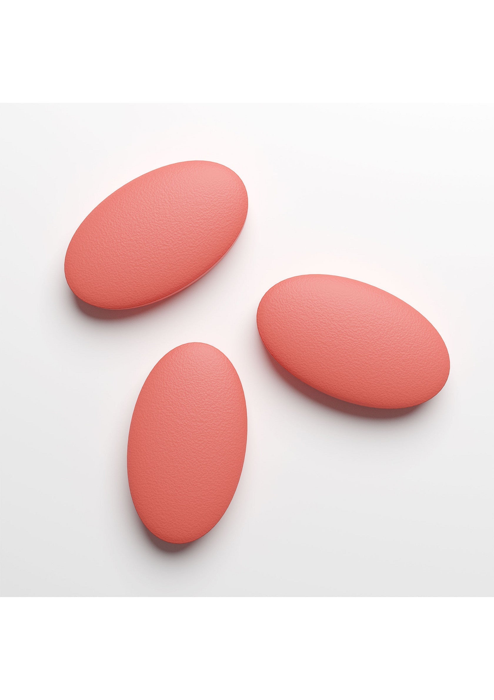 Trois pierres décoratives ovales corail pour une décoration intérieure élégante et moderne.; Drie koraalkleurige ovale decoratieve stenen voor stijlvolle, moderne interieurdecoratie.; Three coral oval decorative stones for stylish, modern home decor.