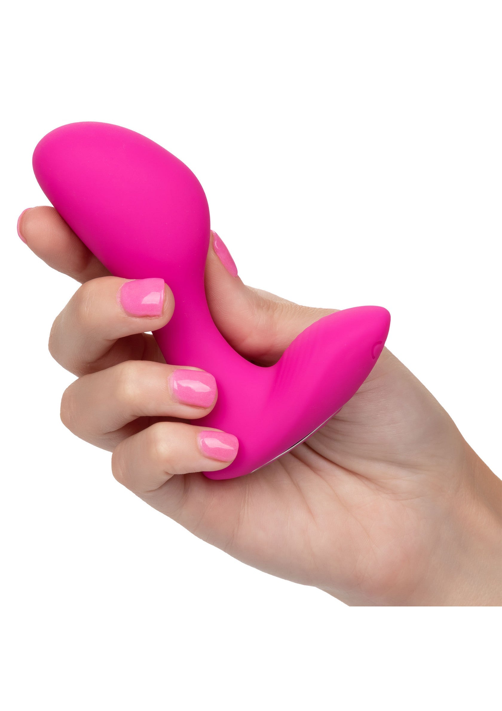 Plug anal vibrant rose dans la main, pour des sensations intenses et agréables.; Roze vibrerende anale plug in de hand, voor intense en aangename sensaties.; Pink vibrating anal plug in hand, for intense and pleasurable sensations.