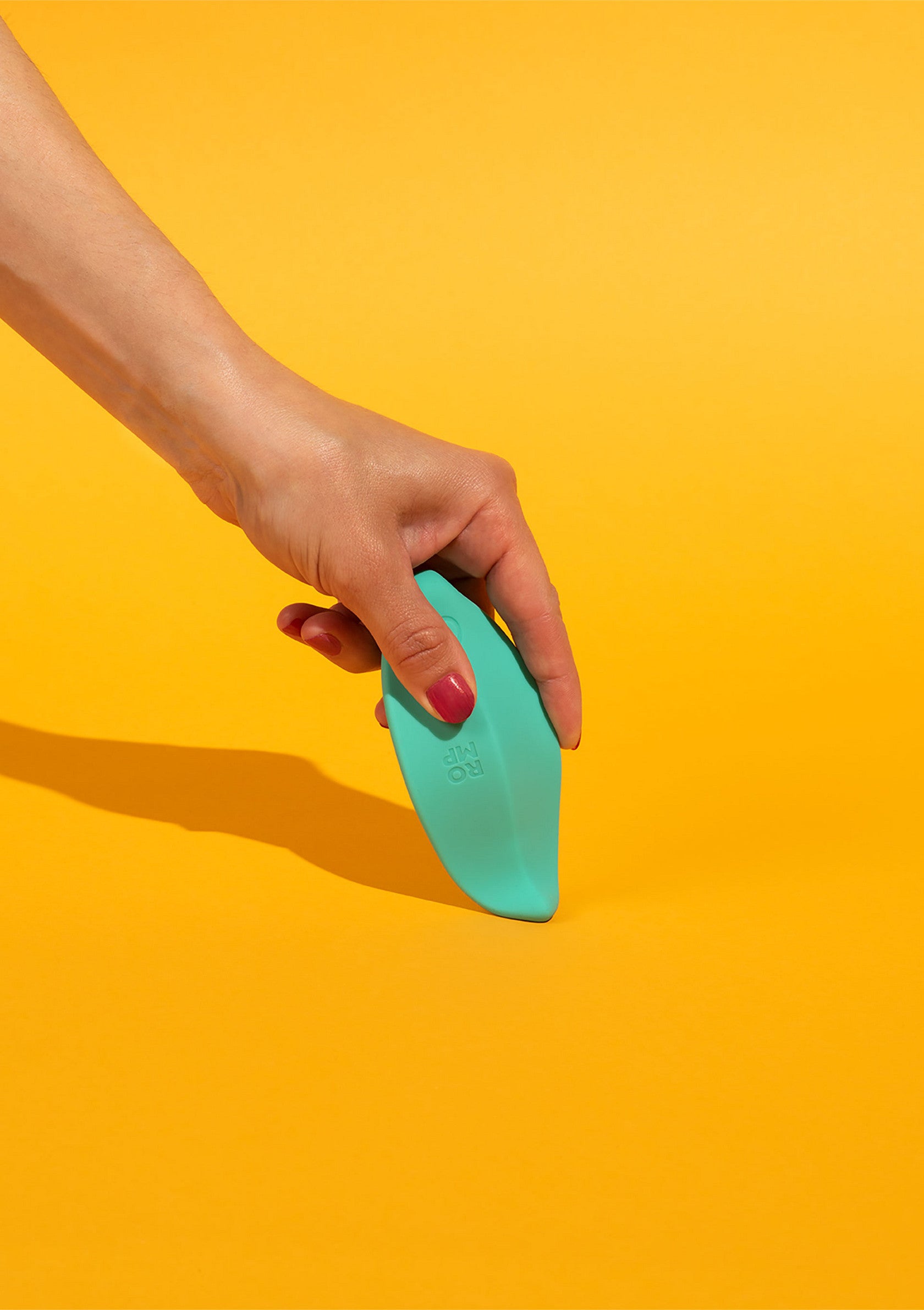 Mains tenant un objet vert sur fond jaune vif. Parfait pour une utilisation et un style de vie actifs.; Hand houdt een groen object vast tegen een felgele achtergrond. Perfect voor een actieve gebruik en lifestyle.; Hand holding a green object against a bright yellow background. Perfect for active use and lifestyle.