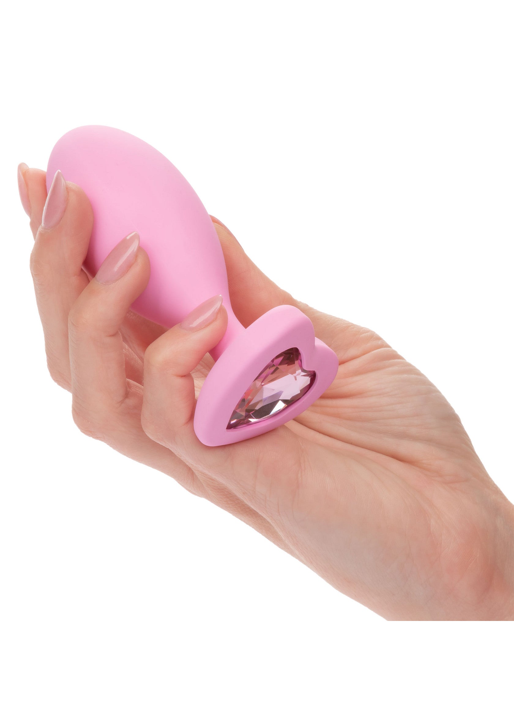 Plug anal rose avec ornement en forme de cœur en cristal, pour une expérience luxueuse et sensuelle.; Roze anaal plug met kristallen hart ornament, voor een luxe en sensuele ervaring.; Pink butt plug with crystal heart ornament, for a luxurious and sensual experience.