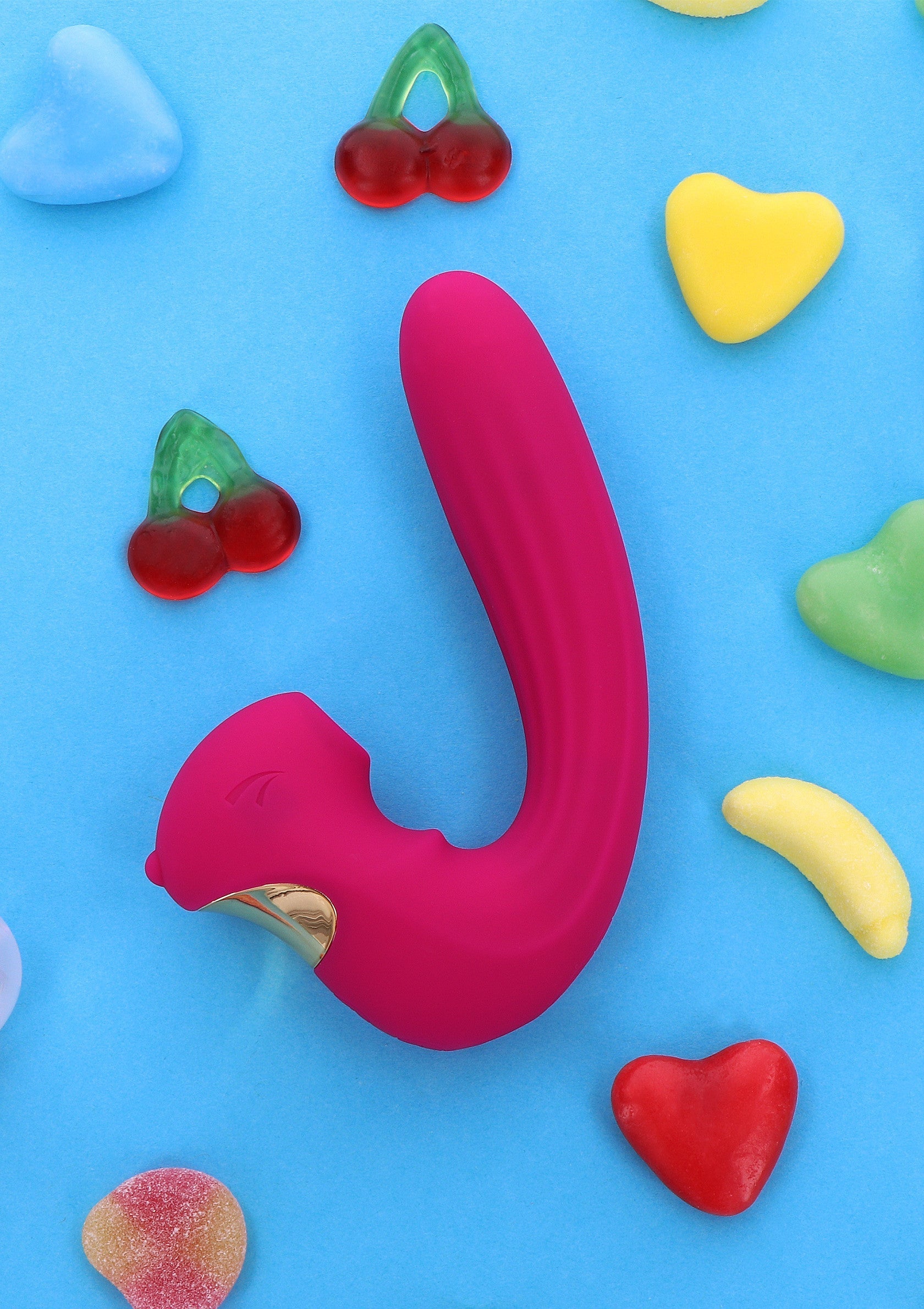 Vibromasseur rose bonbon pour adultes, entouré de bonbons colorés. Plaisir et gourmandise garantis !; Roze vibrator voor volwassenen, omringd door kleurrijke snoepjes. Plezier en zoetheid gegarandeerd!; Pink adult vibrator surrounded by colorful candies. Fun and sweetness guaranteed!