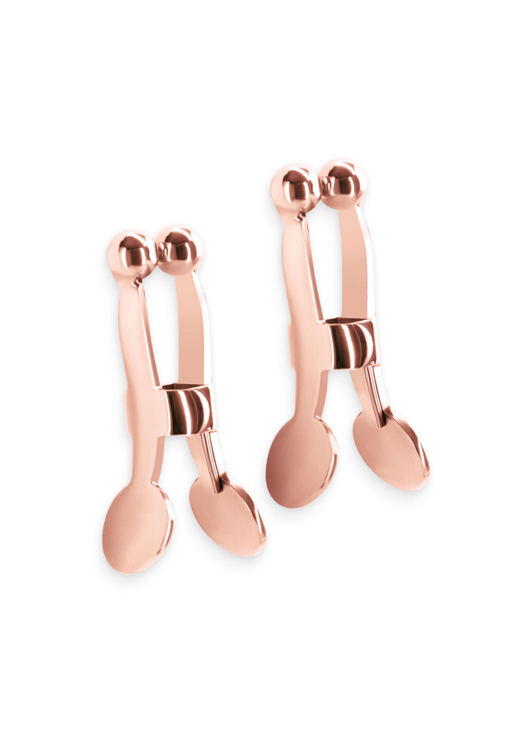 Pinces à tétons en or rose. Accessoires coquins pour adultes.; Roze gouden tepelklemmen. Speelse accessoires voor volwassenen.; Rose gold nipple clamps. Playful accessories for adults.