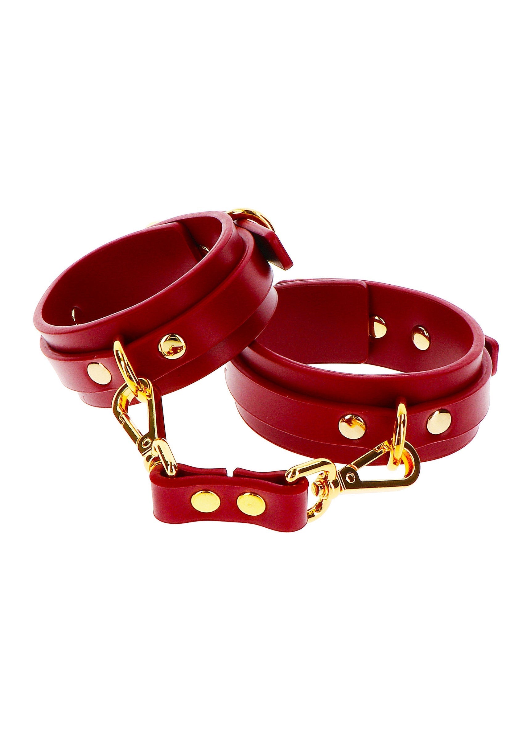 Menottes rouges en cuir pour jeux coquins.; Rode lederen handboeien voor stout spel.; Red leather wrist restraints for kinky games.