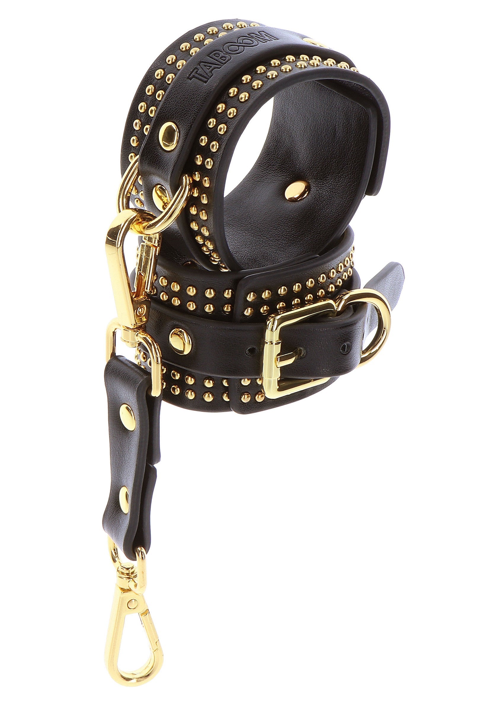 Menottes en cuir noir cloutées dorées avec boucles et fermoirs.; Zwarte leren handboeien met gouden studs, gespen en sluitingen.; Black leather handcuffs with gold studs, buckles and clasps.